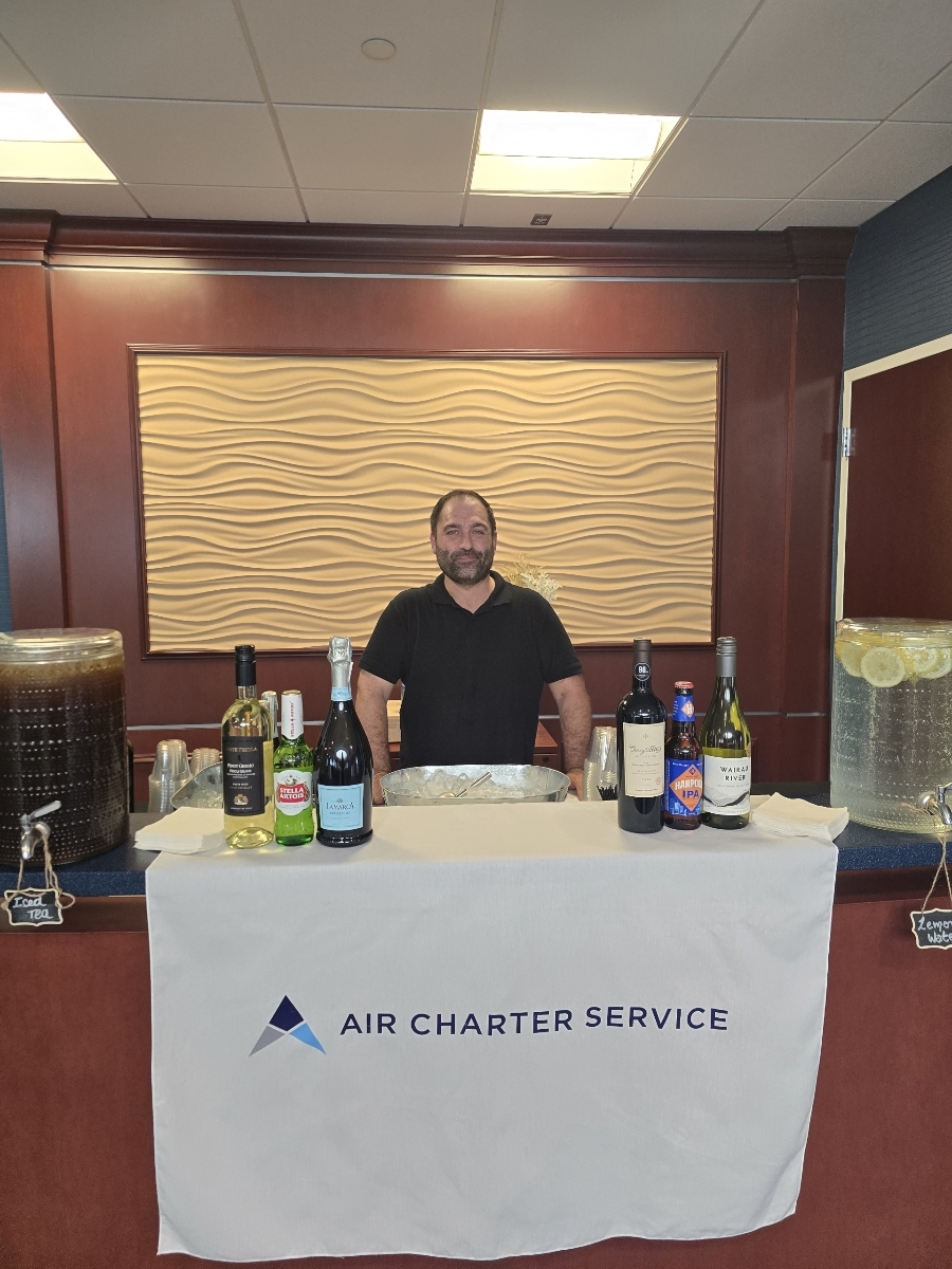 Bartender at a clean service table bar setup.