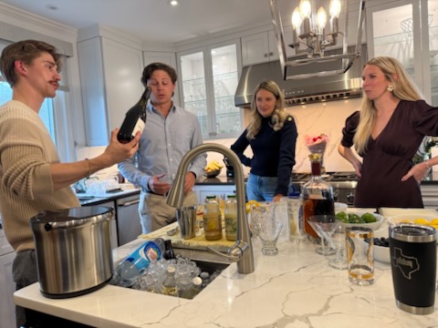 Bartender mixing a craft cocktail at an event.
