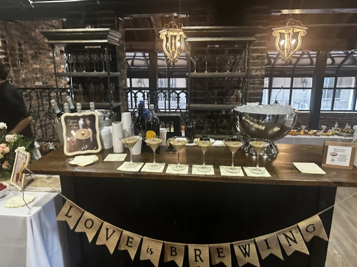 Indoor event bar with bottles and glassware prepared.